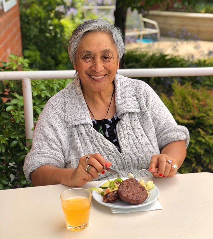 A resident enjoying their meal outside